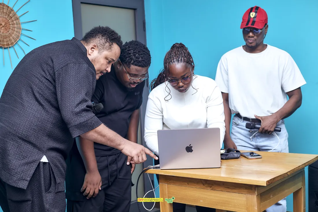 Community members gathered around a laptop demonstration